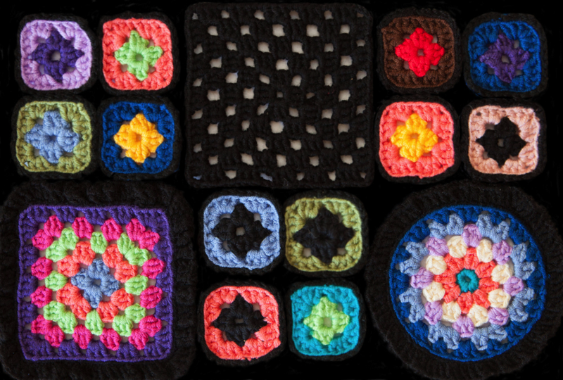 A close up of the granny square design ready to upload, which includes granny squares of varying size connected by black crochet at the top of solid black at the bottom and on the sides. 