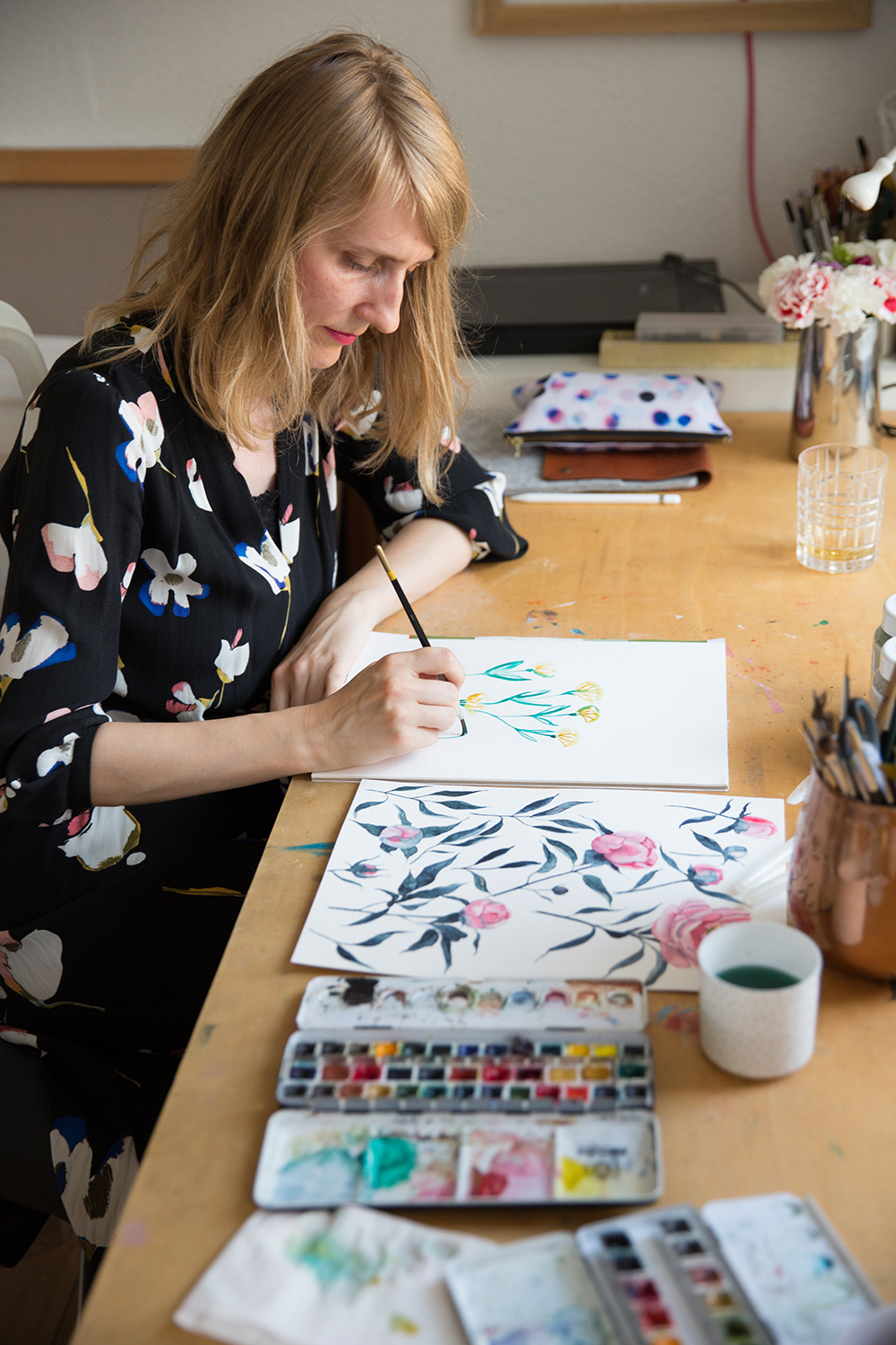 Spoonflower designer youdesignme painting at her desk