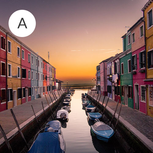A row of colorful buildings with water running down the center | Spoonflower Blog 