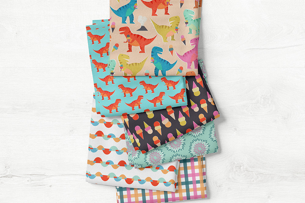 A collection of fabrics a client chose for a custom bib set featuring designs from Kristina's collection Dino Ice Cream Party | Spoonflower Blog 