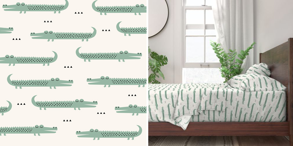 On the left: close up of Claudia's design Crocodile Ivory, which features sleeping light green crocodiles. Their faces are pointing in different directions in alternating rows, left then right. On the right: Crocodile Ivory as seen on a bed sheet set on sheets and pillowcases on a wooden brown bed with tall plants and a window with a white curtain behind it.