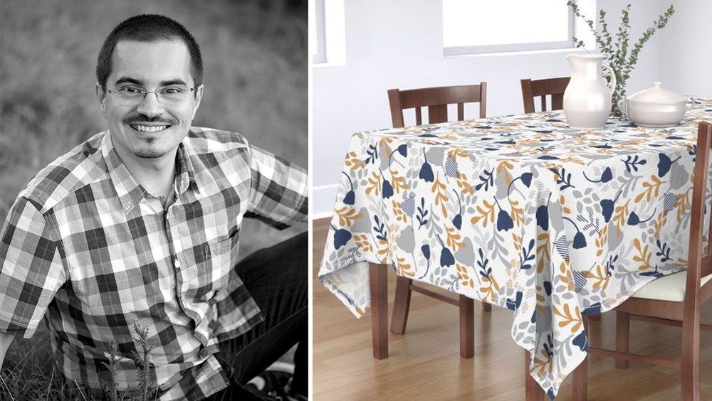 Left image: Vilmos Varga portrait. Right image: Vilmos's design Monotone Foliage is shown on a tablecloth on a dark brown wooden table. Two chairs are on one side and part of another chair is shown on the other side. There is a a white carafe and dish on the table along with a clear vase with long straight stems of green flowers. The tablecloth's design has a white background and navy, light gray and dark yellow flowers twisting and floating through the background.
