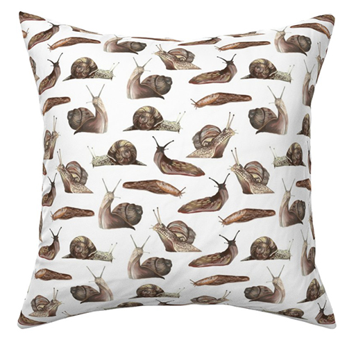 Marta's Snails and Slugs design on a pillow. The design has a white background and brown slugs and snails heading in all directions.  