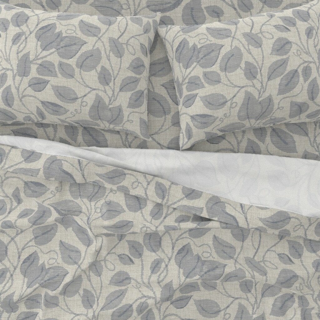 A topdown bedding view featuring a design of ikat vines in neutral colors
