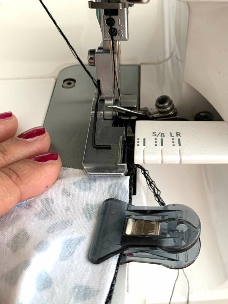Sewing machine with fabric underneath held by a quilting clip