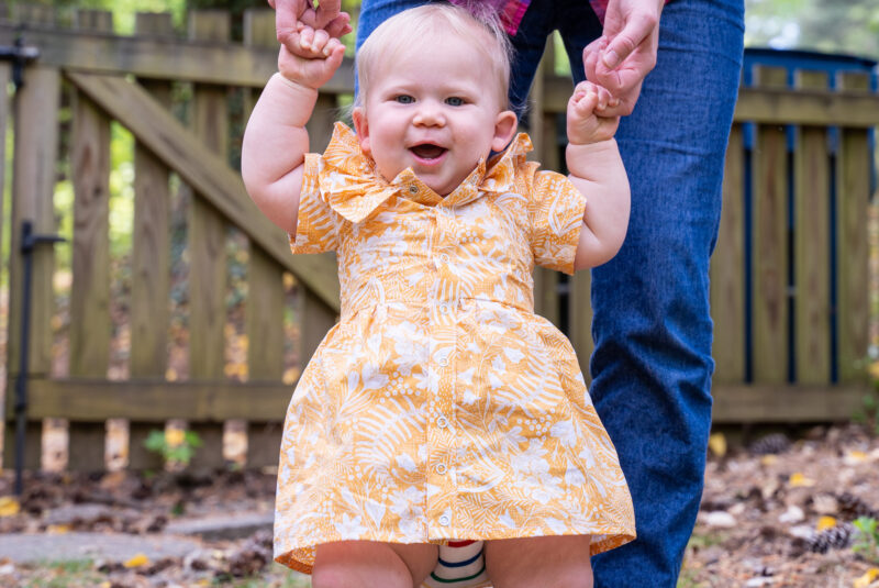 Baby with yellow ruffled dress