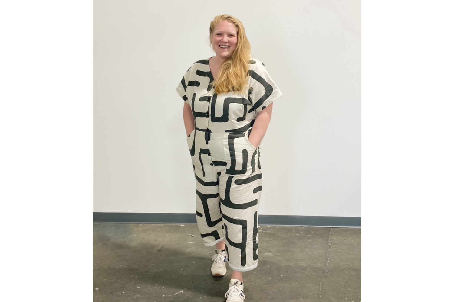 Model wearing jumpsuit with black and white geometric shapes