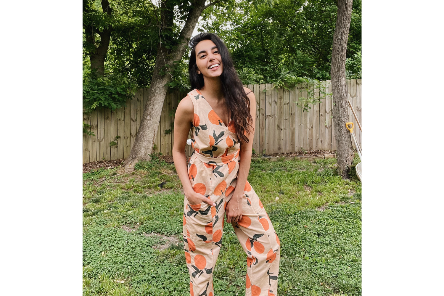 Model wearing jumpsuit with citrus pattern
