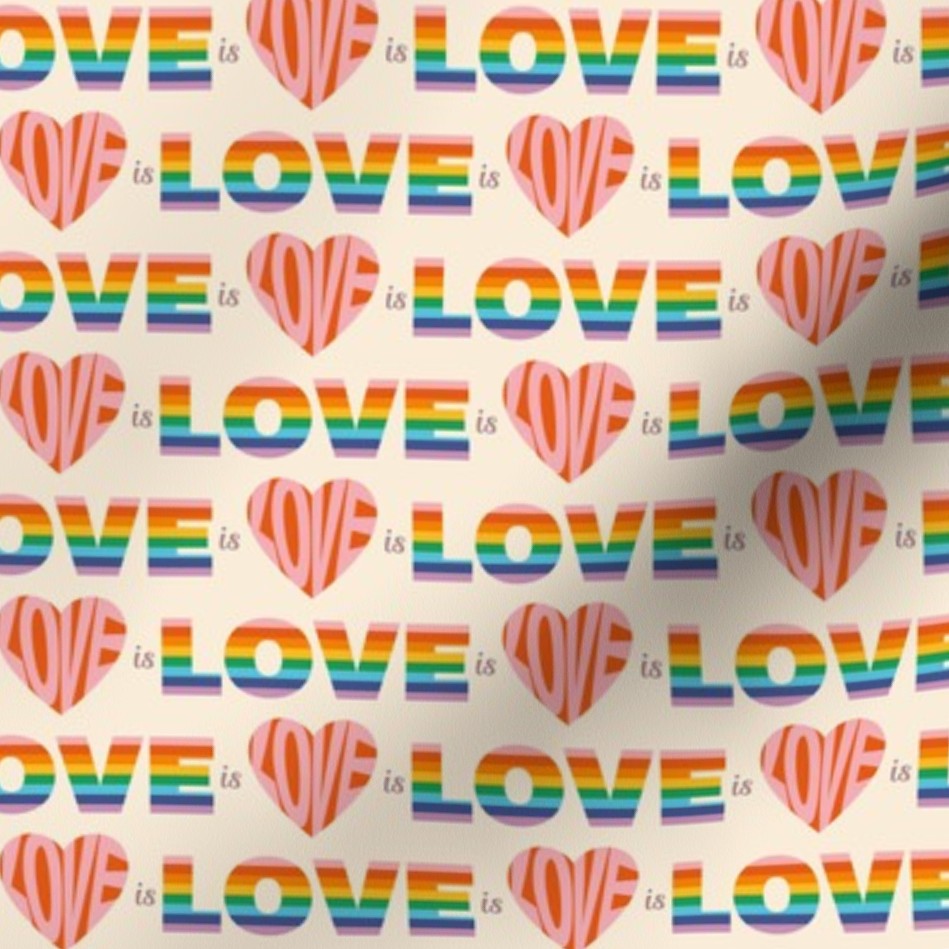 Fabric with the word love repeated in a rainbow or heart pattern