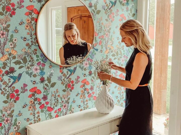 Floral wallpaper in an entryway with a mirror