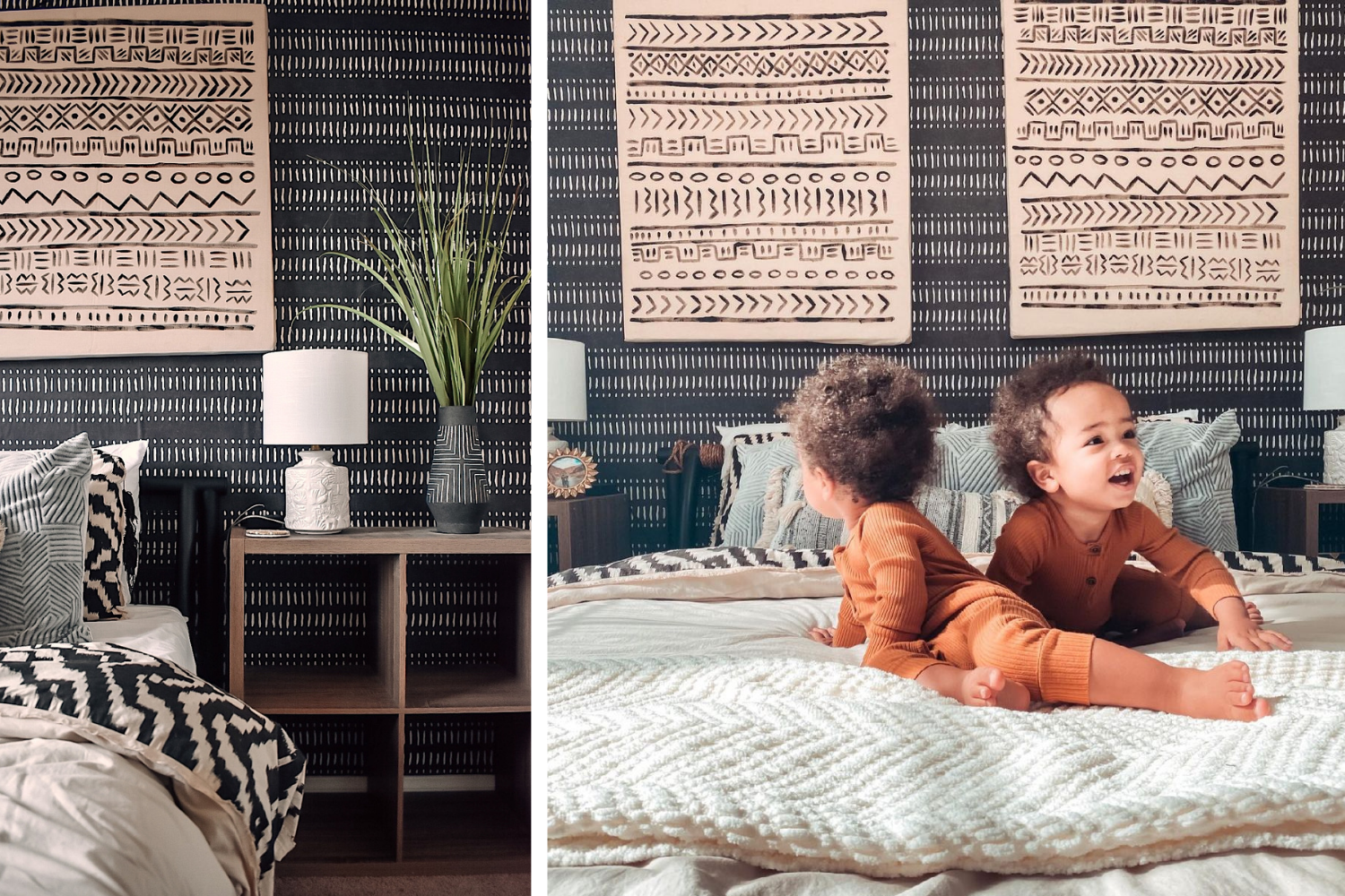 Two toddlers on a bed in a room with an expressive wallpaper pattern