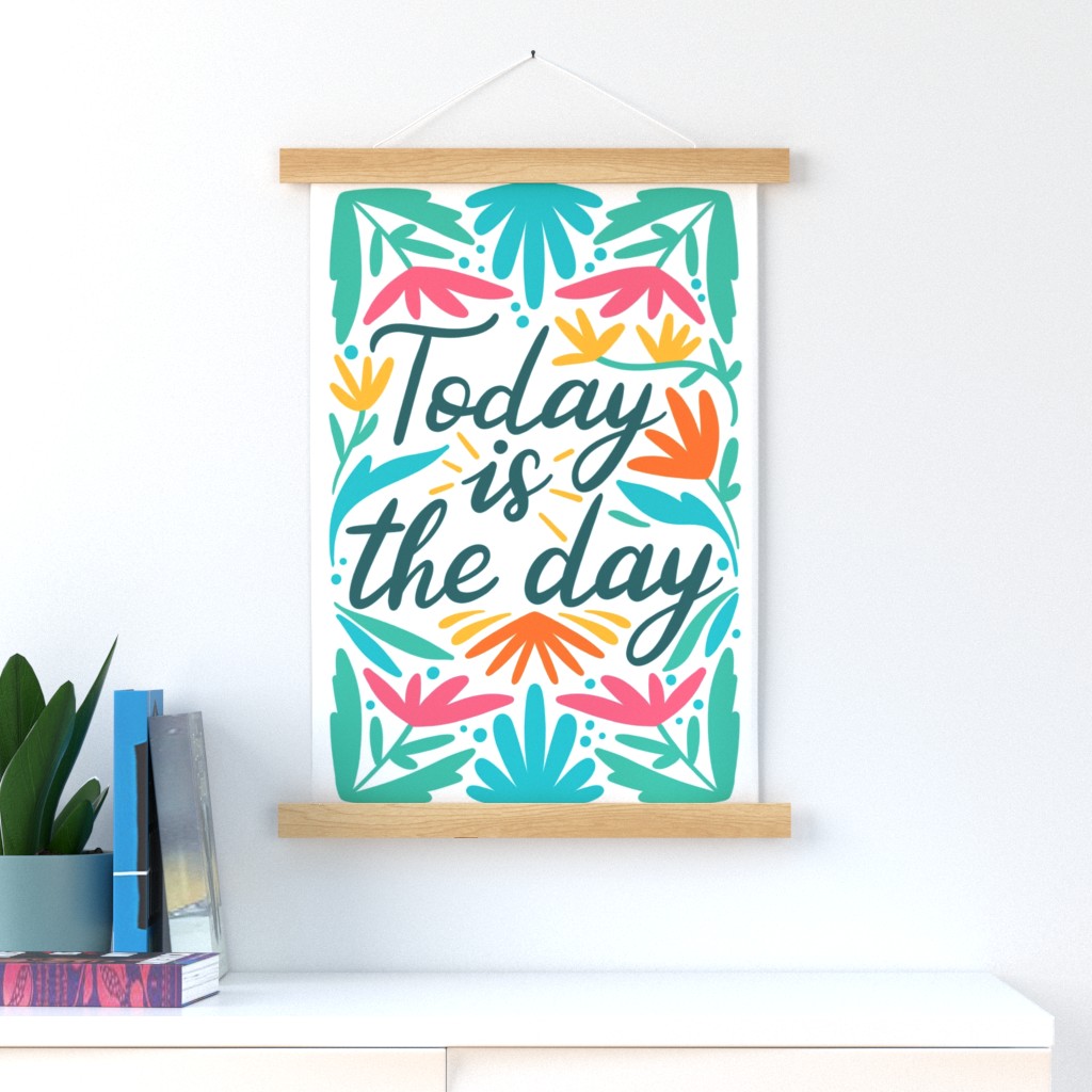 A wall hangings that says "Today is the day"
