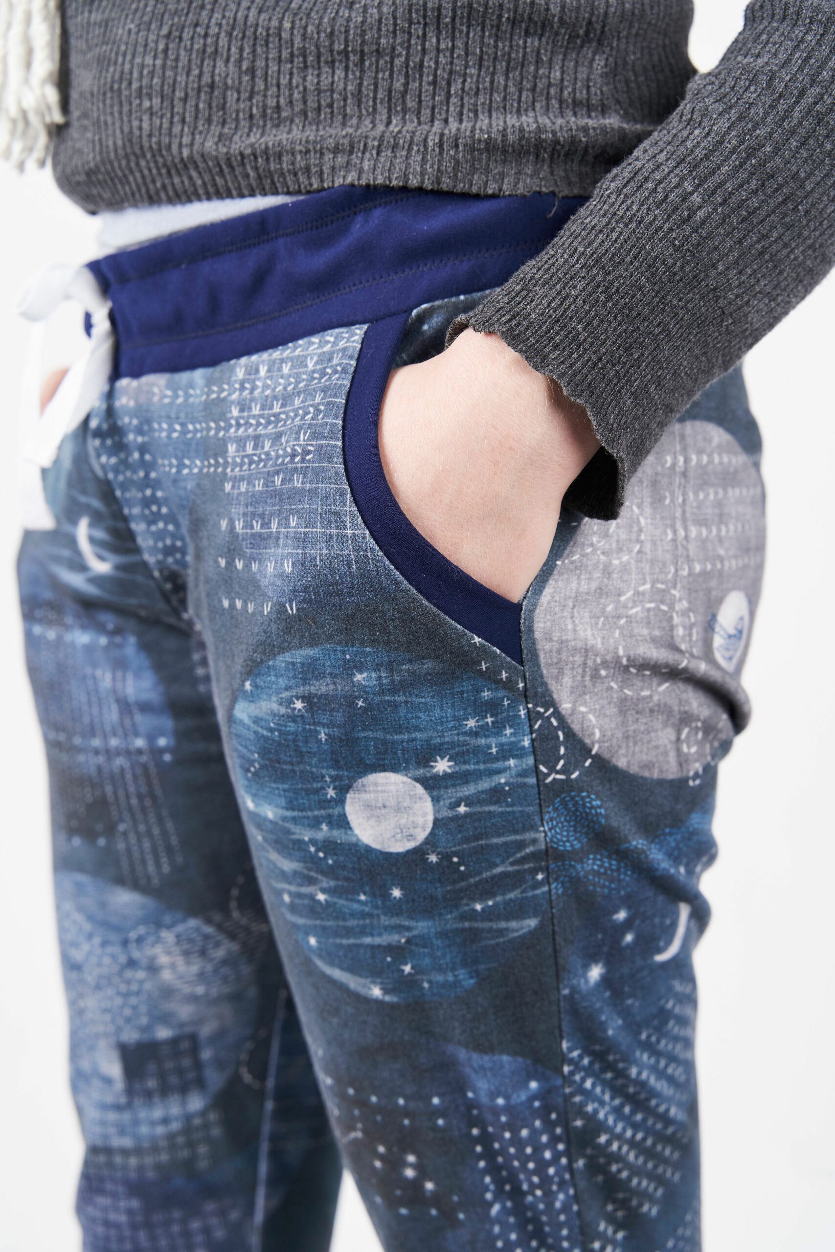 Livian wearing their blue joggers with moon images