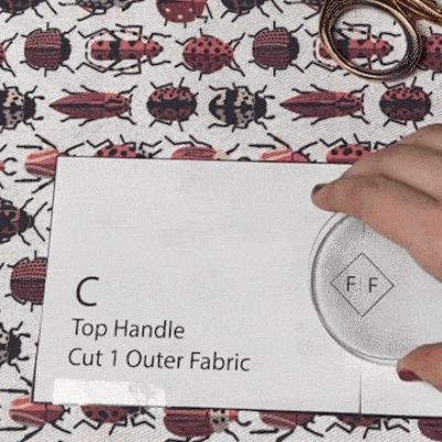 GIF: Using fabric scissors and pattern weights to transfer pattern to beetle fabric