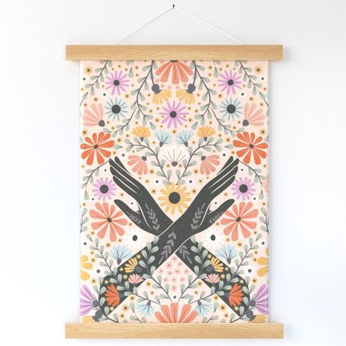 wall hanging with florals and two black arms in a cross