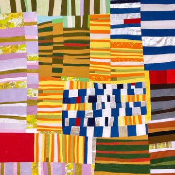 A quilt comprised of many small striped blocks, turned both horizontally and vertically. Small strips of green, yellow, white, blue, black, red and white have been combined together to form a quilt of many colors, based on the colors in Sherri’s childhood home.