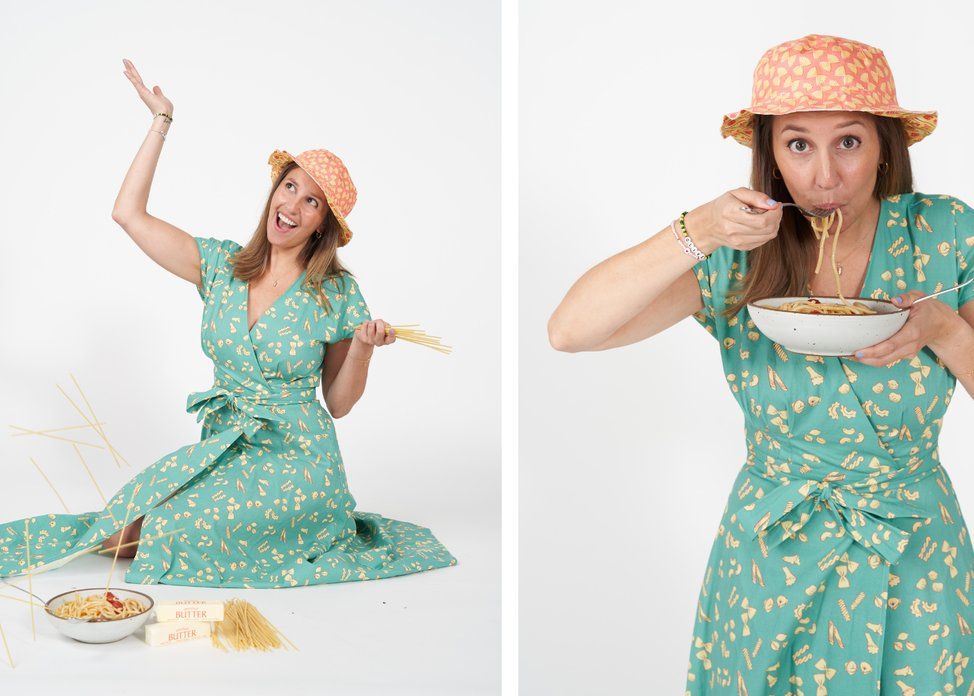 Theresa wears a blue green wrap dress with a pasta print and holds a white bowl of buccatini pasta. She is also wearing a pink bucket hat with a farfalle pasta print.