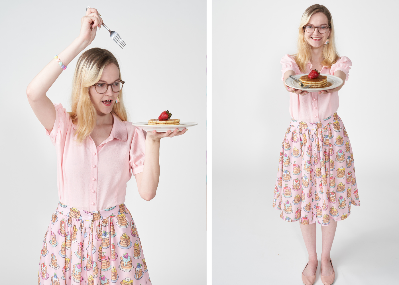 Anna is a white woman with long reddish blonde hair wearing a pink button up blouse and pink pancake button up skirt. She is holding a plate of pancakes with syrup and strawberry.