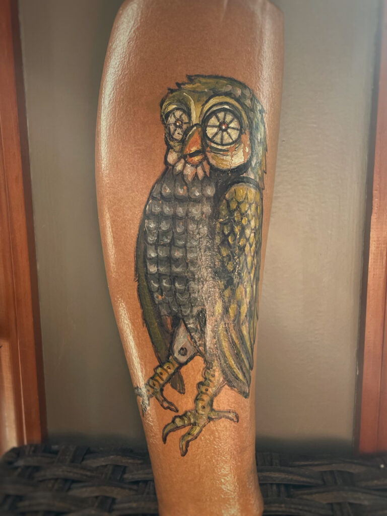 Photograph of an owl Jennifer painted on the back of a mechanical prosthesis. 