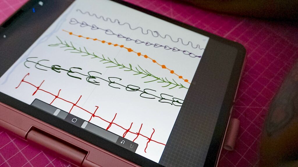 A closeup of a design after it was drawn on an iPad by Aurora. The design has a light blue background and vertical lines in varying colors throughout.