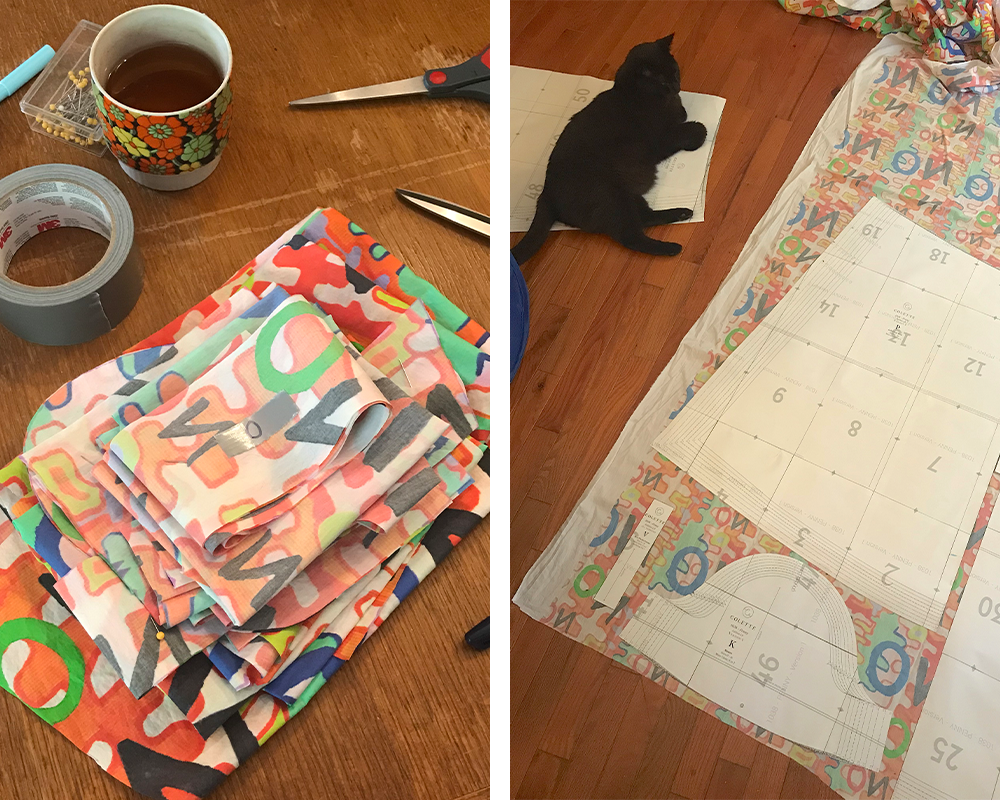 Two photos have been placed side by side in a rectangle. On the left, fabric printed with Bri’s “No” design with the word “no” in blue, green, orange, red and black lays folded on a brown wooden table. A roll of duct tape, a vintage floral coffee cup, a few pens and some sewing pins are to the top left of the fabric. The edges of two pairs of scissors and a pen are to the fabric’s right. On the right, cut out pattern pieces for Seamwork’s Penny dress lay on the wrong side of the fabric with the ’no’ design. A black cat sits to the top left of the photo.