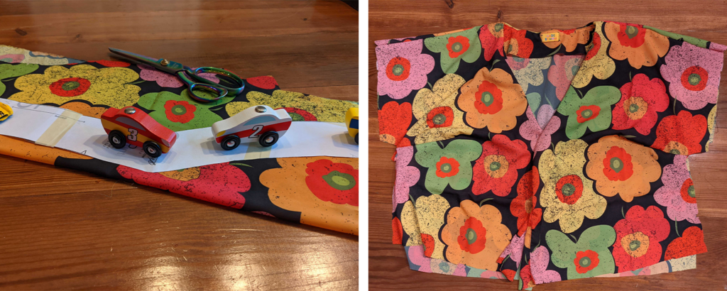 Two images lay side by side in a rectangle. On the left, a folded piece of fabric lays on a wooden floor. A thin paper pattern piece, two wooden toy children’s cars and a pair of scissors lay on top of the fabric. On the right, a button-up shirt lays on a wooden floor. The pattern on the fabric in both photos has large red, orange, yellow, pink and green flowers on a black background.