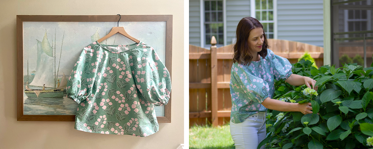 Two photos have been placed side by side in a rectangle. On the left, a shirt hangs on a wooden hanger from the top of a painting featuring sailboats on the ocean. The shirt has gathered puffy mid-length sleeves and a sage background with white flowers and green leaves growing on green stems floating through it. On the right, Suz wears the shirt while looking at early blooms on a magnolia bush.