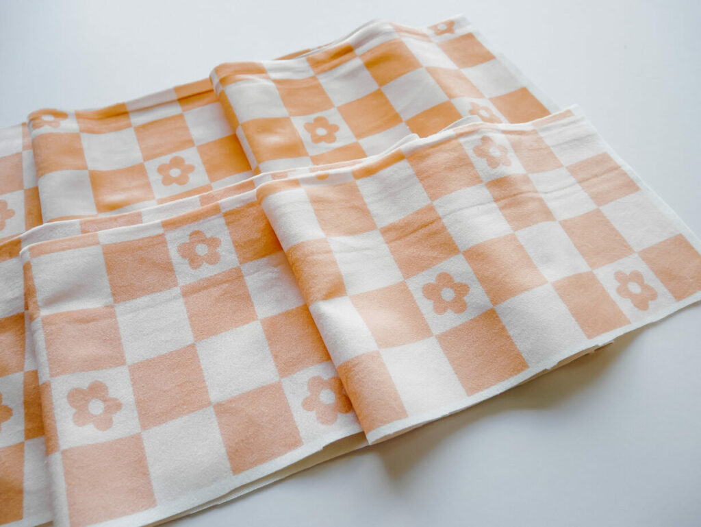 orange and white checkered fabric on a white table