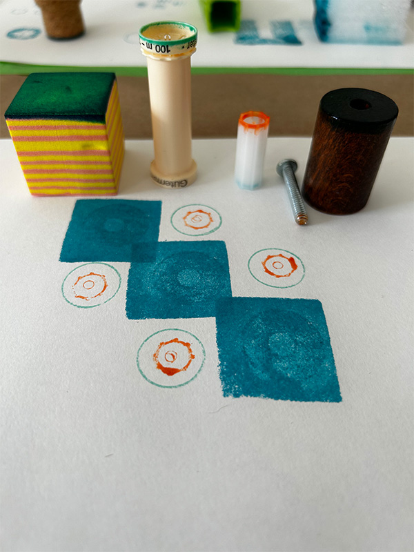 Found items are on a white paper in front of their prints organized as as diagonal design.