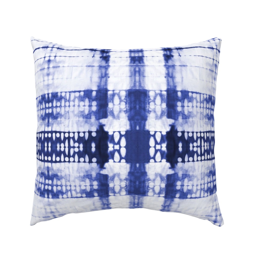 A large pillow sham featuring an indigo shibori design by alysonjonlife. The design is blue indigo painted on a white background.