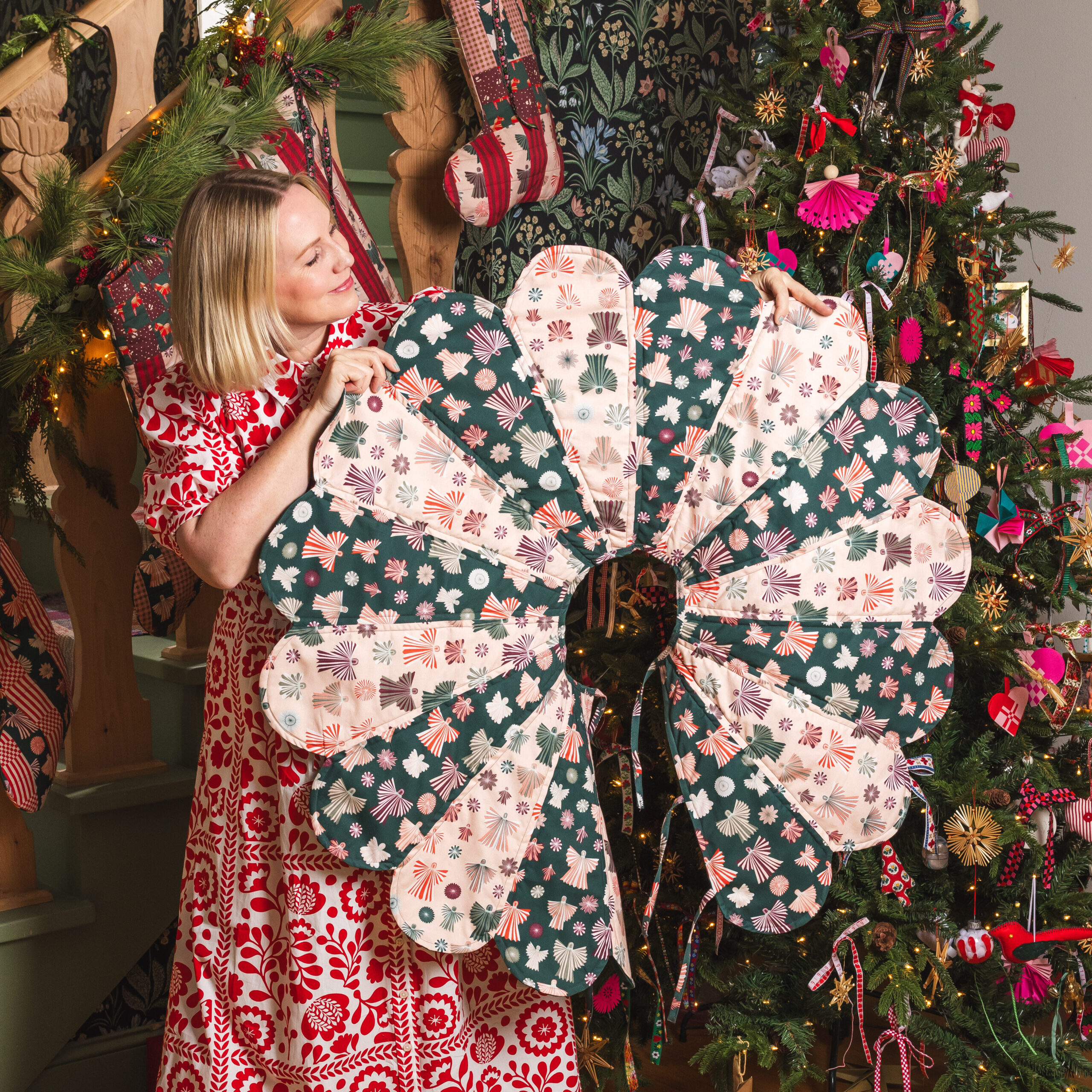Photo of Brittany of The House That Lars Built holding out her handmade scalloped Christmas Tree Skirt